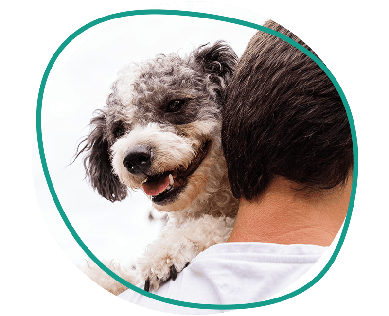 man holding a smiling dog