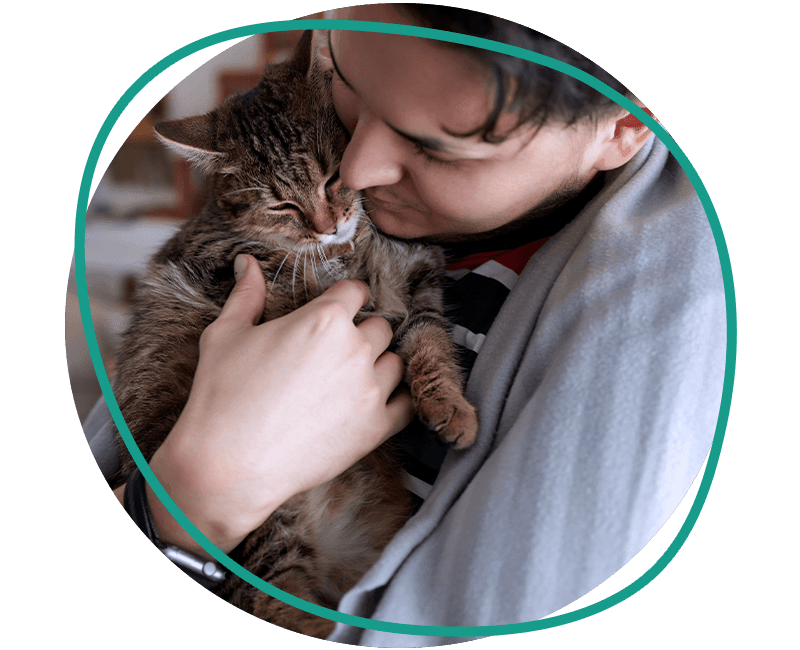 young man t shirt holding cat
